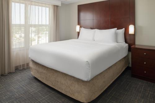 a large white bed in a hotel room at Residence Inn by Marriot Clearwater Downtown in Clearwater