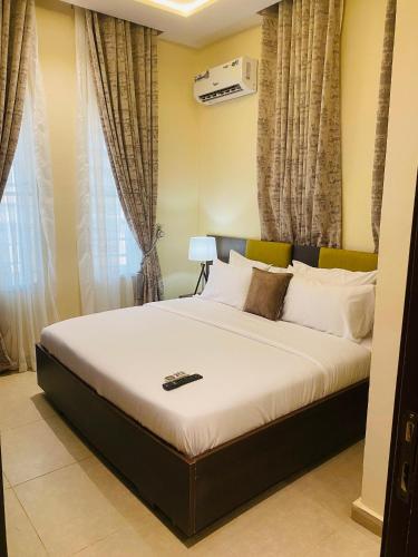 a bedroom with a large bed in front of a window at KIFA Stays in Laniya