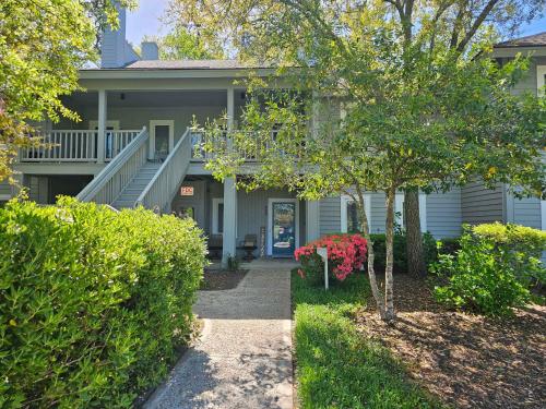 a house with bushes and a walkway in front of it at Teal Lake 212 in North Myrtle Beach