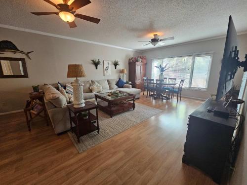 a living room with a couch and a table at Teal Lake 212 in North Myrtle Beach