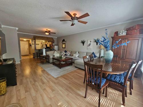 a living room with a table and a couch at Teal Lake 212 in North Myrtle Beach