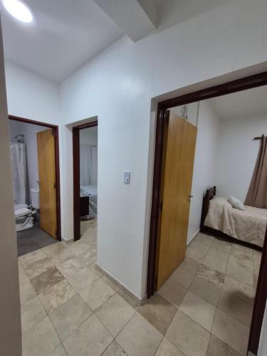 a room with two doors and a bed at Rincón del Sol en Albardón in Albardón