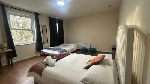 a bedroom with two beds and a window at Comfort at Sunderlands in Forest Hill