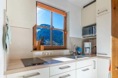 a kitchen with a sink and a window at Sonnenschein in Bad Hindelang