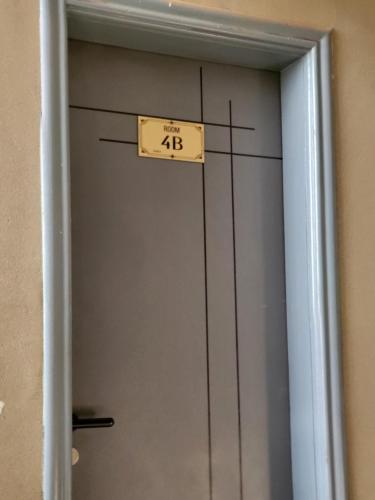 a door with a sign on it that says at Ham Apartments in Kampala