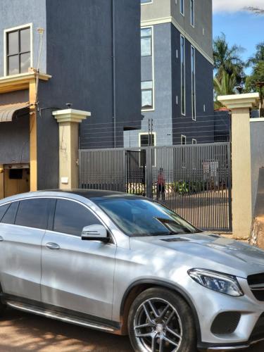 a silver car parked in front of a building at Ham Apartments in Kampala