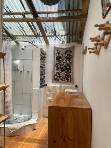 a bathroom with a shower and a wooden counter at The Black Sheep Inn in Chugchilán