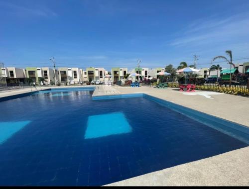 a swimming pool with blue water in a resort at Urban Oasis in Manta