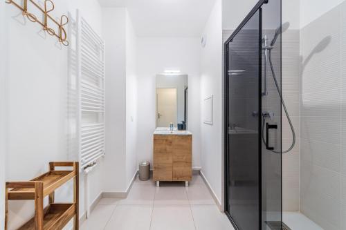 a bathroom with a shower and a sink at 2 Bedroom Apartment for 6 with Private Parking - Elevator - High-Speed WiFi in Champigny-sur-Marne