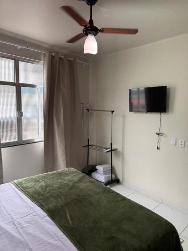 a bedroom with a bed and a ceiling fan at Angra Prime Centro in Angra dos Reis