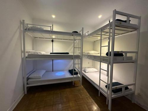 a room with four bunk beds in a room at Refugio Madalena Hostel in São Paulo