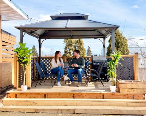 a man and woman sitting under a gazebo at Howard Johnson by Wyndham Fort St. John in Fort Saint John