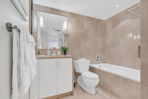 a bathroom with a toilet and a tub and a sink at Heaven on Washington Fully Furnished Apartments in Washington, D.C.