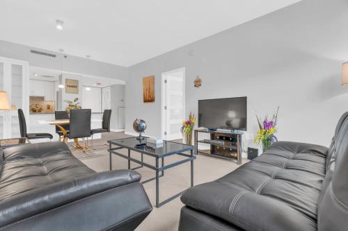 a living room with a couch and a tv at Heaven on Washington Fully Furnished Apartments in Washington, D.C.