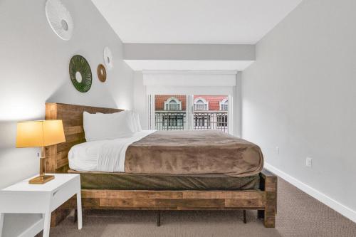 a bedroom with a bed and a desk and a window at Heaven on Washington Fully Furnished Apartments in Washington, D.C.