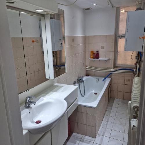 a bathroom with a sink and a bath tub at veeweyde in Brussels