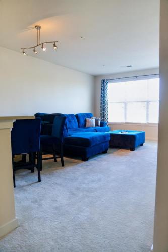 a living room with a blue couch and a table at Cozy & inviting 2BD 2BTH Apt Home in Owings Mills