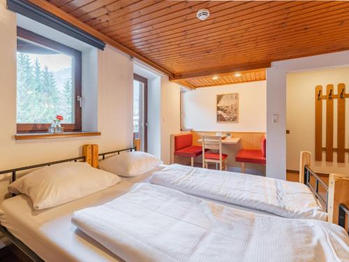a bedroom with two beds and a dining room at Grieswirt L in Itter