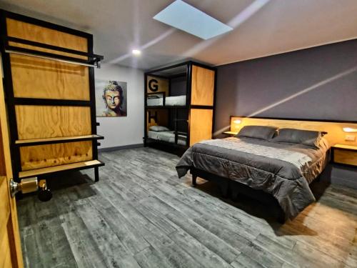 a bedroom with a bed and a wooden floor at Ruta Elqui in Pisco Elqui
