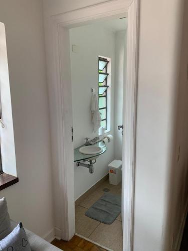 a bathroom with a sink and a mirror at Refugio Madalena Hostel in São Paulo