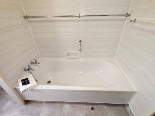 a white bath tub in a white bathroom at Te Ra Waitangi in Paihia