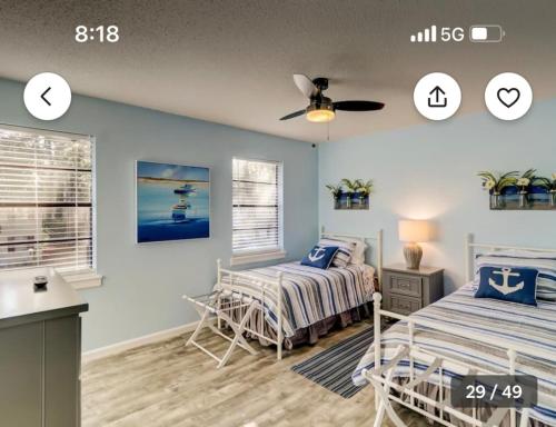 a bedroom with two beds and a ceiling fan at Pet Friendly | Pool | Tennis | Walk to Shops in Hilton Head Island