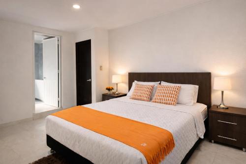 a bedroom with a large bed with two lamps and a window at Posada Lkjay Providencia Isla in Providencia
