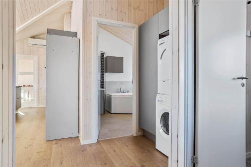 a white laundry room with a washer and dryer at 30434-Odder-Strandvaenget-10 in Odder
