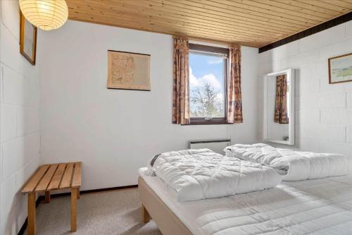 a room with three beds and a table and a window at 30486-Odder-Kirkeager-5 in Odder
