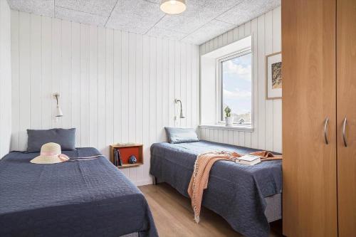 a bedroom with two beds and a window at 30467-Odder-Ravnsager-15 in Odder