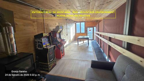 a hallway with two arcade games in a building at CA Granja Paraíso, Oasis Rural & Bienestar in Cangas de Onís
