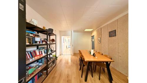 a dining room with a table and a book shelf at Cozy Room in the heart of Rødby! 5km from Femern & Puttgarden! in Rødby