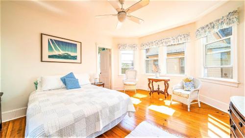 a bedroom with a bed and a ceiling fan at The Perry Street Hideaway in Cape May