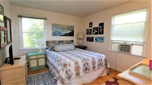a bedroom with a bed and two windows at 3 Bedroomgorgeous Sunset Views!! in West Cape May