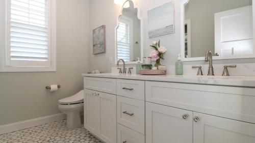 a white bathroom with a sink and a toilet at Seashell Sanctuary in Cape May
