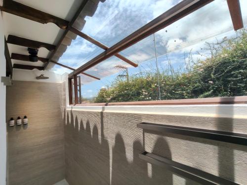 a bathroom with a large window with a view at Hotel Boutique El Carmel in Villa de Leyva