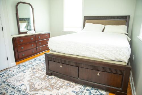 a bedroom with a bed with a dresser and a mirror at Private Room #3 Fall River MA in Fall River