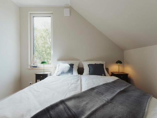 a bedroom with a large bed and a window at Urlaub genießen in Sagard auf Rügen in Sagard