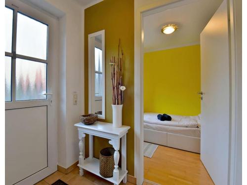 a hallway with a room with a bed and a mirror at Ferienwohnung im Erholungsort Suhl in Suhl