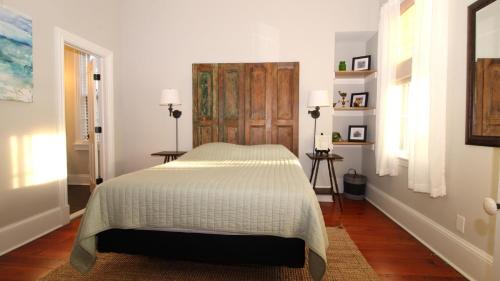 a bedroom with a bed with a wooden door at The Bayberry House in Cape May