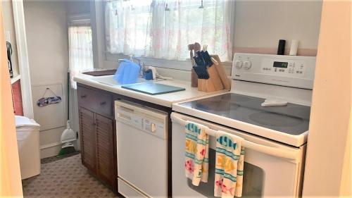 a kitchen with a stove top oven next to a sink at Rulons Cape May Diamond, 1St in Cape May