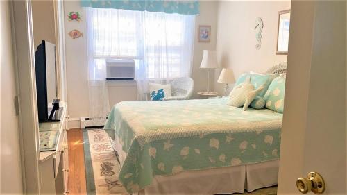 a bedroom with a bed and a television and a window at Rulons Cape May Diamond, 1St in Cape May