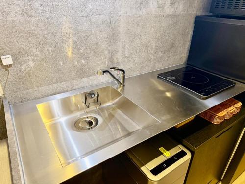 a stainless steel sink in a small kitchen at Villa Monica 30sec in Noritake-Shinmachi
