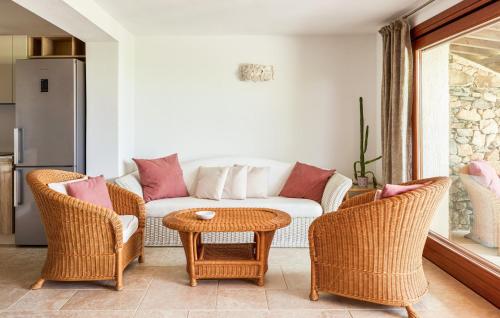 a living room with a couch and chairs and a table at Villa Rosalba in Olbia