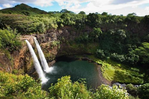 a pool of water in front of a waterfall at Kauai Adventure fully equipped FJ Cruiser Rooftop Camper in Anahola