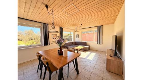 a living room with a table and a couch at Charming Villa - Lalandia & Puttgarden & Femern in Rødby