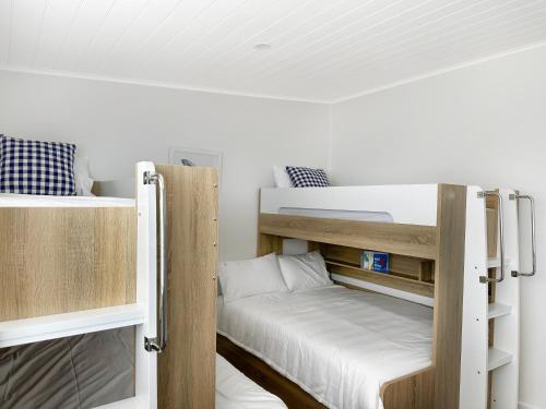 a couple of bunk beds in a room at 180 Degrees - Amazing Bay Views in St Helens