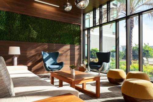 a living room with couches and chairs and a table at Residence Inn by Marriott Orlando at Millenia in Orlando