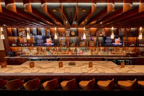 a bar with a large table and chairs at Choctaw Casino & Resort Grant, Trademark Coll by Wyndham in Grant