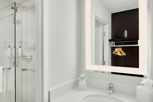 a white bathroom with a sink and a mirror at Fairfield Inn and Suites Chicago Downtown/ Magnificent Mile in Chicago